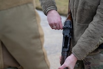 U.S. Air Force Airman 1st Class Kyleigh Mauldin, a ceremonial guardsman with the U.S. Air Force Honor Guard Firing Party, pulls the charging handle of an M14 rifle to clear the weapon during training on Joint Base Anacostia-Bolling, Washington, D.C., March 3, 2026. The Firing Party trained on supporting memorial operations which consist of funeral honors, cordon, intermediate drill and parades. (U.S. Air Force photo by Hayden Hallman)
