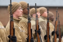U.S. Air Force Airman 1st Class Isaiah Lolopulos, left, a ceremonial guardsman with the U.S. Air Force Honor Guard Firing Party, stands at the position of attention during training on Joint Base Anacostia-Bolling, Washington, D.C., March 3, 2026. While assigned to the Honor Guard, Airmen in the Firing Party maintain a rigorous training schedule of two to six hours each day and support memorial operations at Arlington National Ceremony. (U.S. Air Force photo by Hayden Hallman)