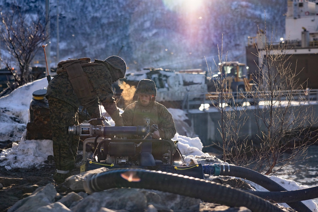 U.S. Marine Corps Cpl. Njomen Usmanjuniorabdulahi, left, and Cpl. Samuel Kutz, both expeditionary fuels technicians with 6th Engineer Support Battalion, 4th Marine Logistics Group, Marine Forces Reserve, turn on a 250-gallon-per-minute pump in Narvik, Norway, March 2, 2026. The Marines set up the bulk fuel equipment to establish a Joint Petroleum Off-the-Shore operation as part of exercise Cold Response 26. A key component of NATO's enhanced vigilance activity Arctic Sentry, exercise Cold Response 26 is a Norwegian-led winter military exercise designed to enhance collective defense capabilities and ensure U.S. readiness to rapidly deploy and seamlessly operate alongside NATO Allies in challenging arctic conditions. (U.S. Marine Corps photo by Staff Sgt. Scott Jenkins)