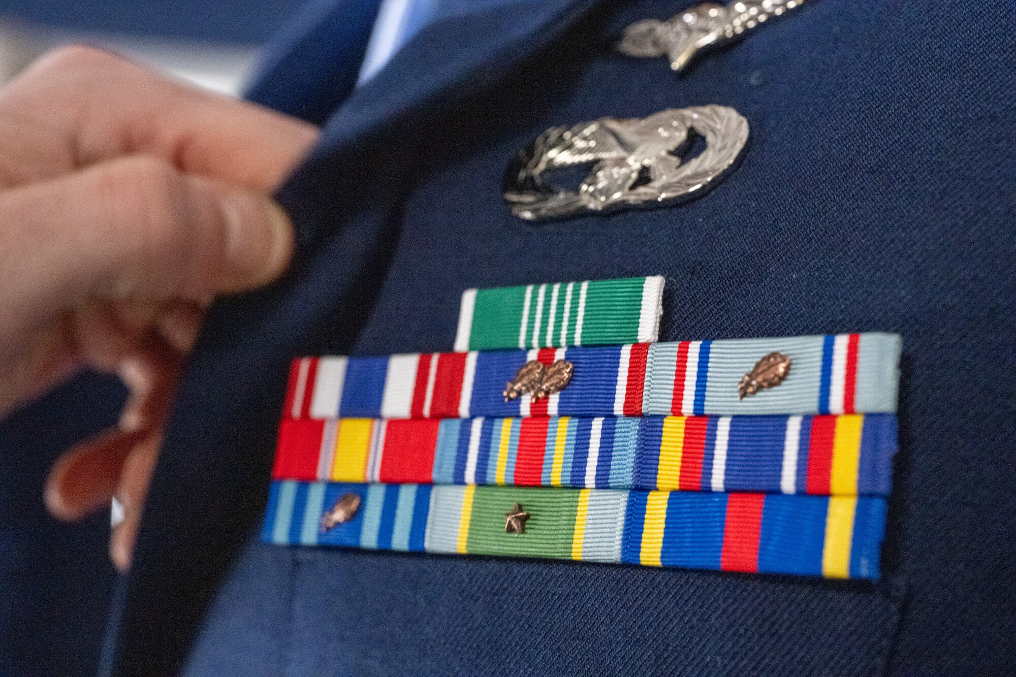 U.S. Air Force Staff Sgt. Kaden Ballentine, 436th Force Support Squadron Airman Leadership School instructor, closely inspects a student’s ribbons during a uniform inspection on the first day of class at Dover Air Force Base, Delaware, March 2, 2026. Each student’s uniform was meticulously inspected by the ALS commandant and instructors. (U.S. Air Force photo by Mauricio Campino)