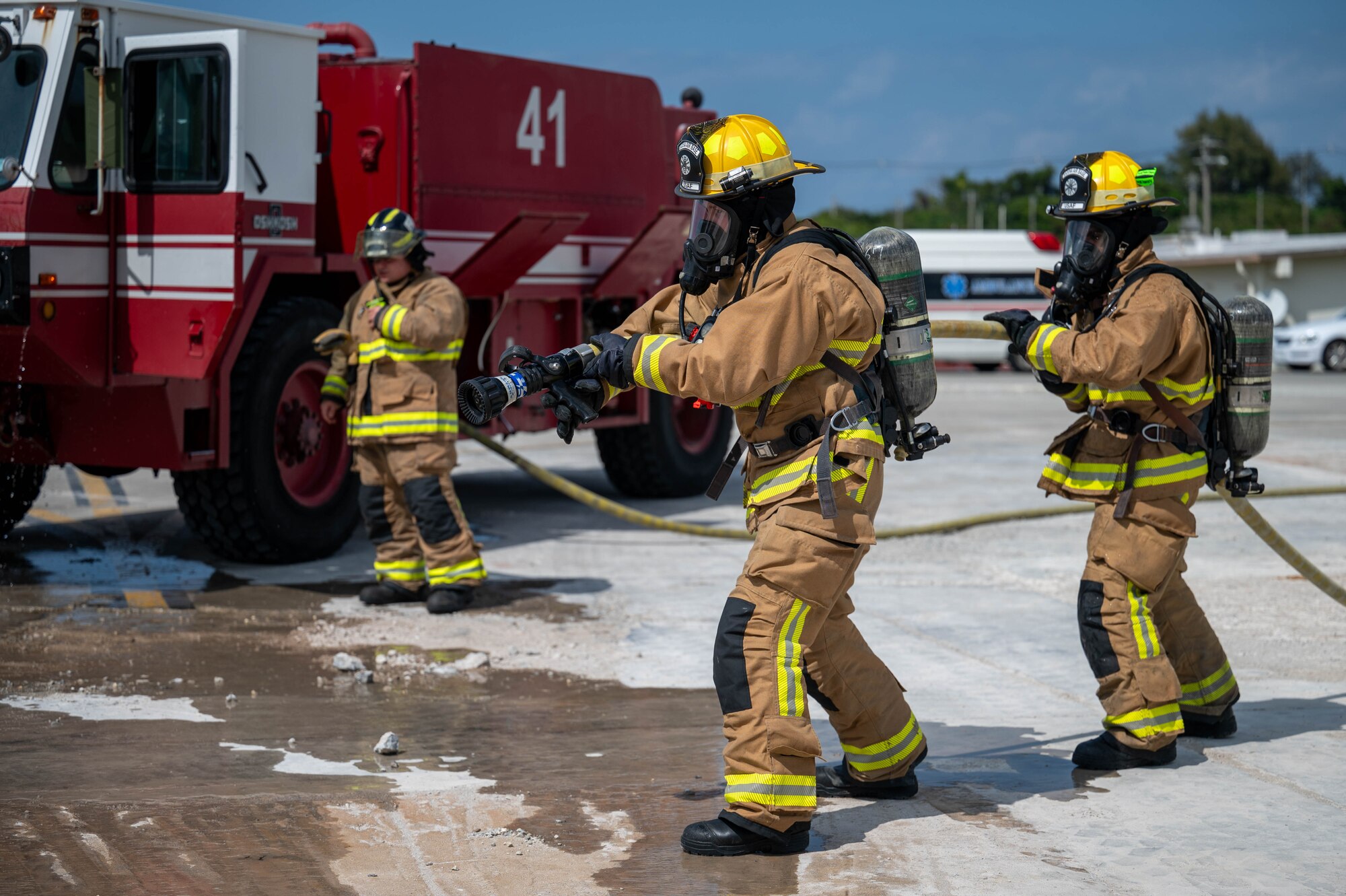 U.S. Air Force 18th Civil Engineer Squadron firefighters prepare to hose a simulated downed aircraft during U.S. Air Force-led operational exercise Beverly Midnight 26 at Kadena Air Base, Japan, Mar. 10, 2026. BM26 enhances U.S. interoperability by fostering an exchange of information and refining shared tactics, techniques and procedures to better integrate defense capabilities in support of regional security. (U.S. Air Force photo by Airman 1st Class Francisco Huerta)