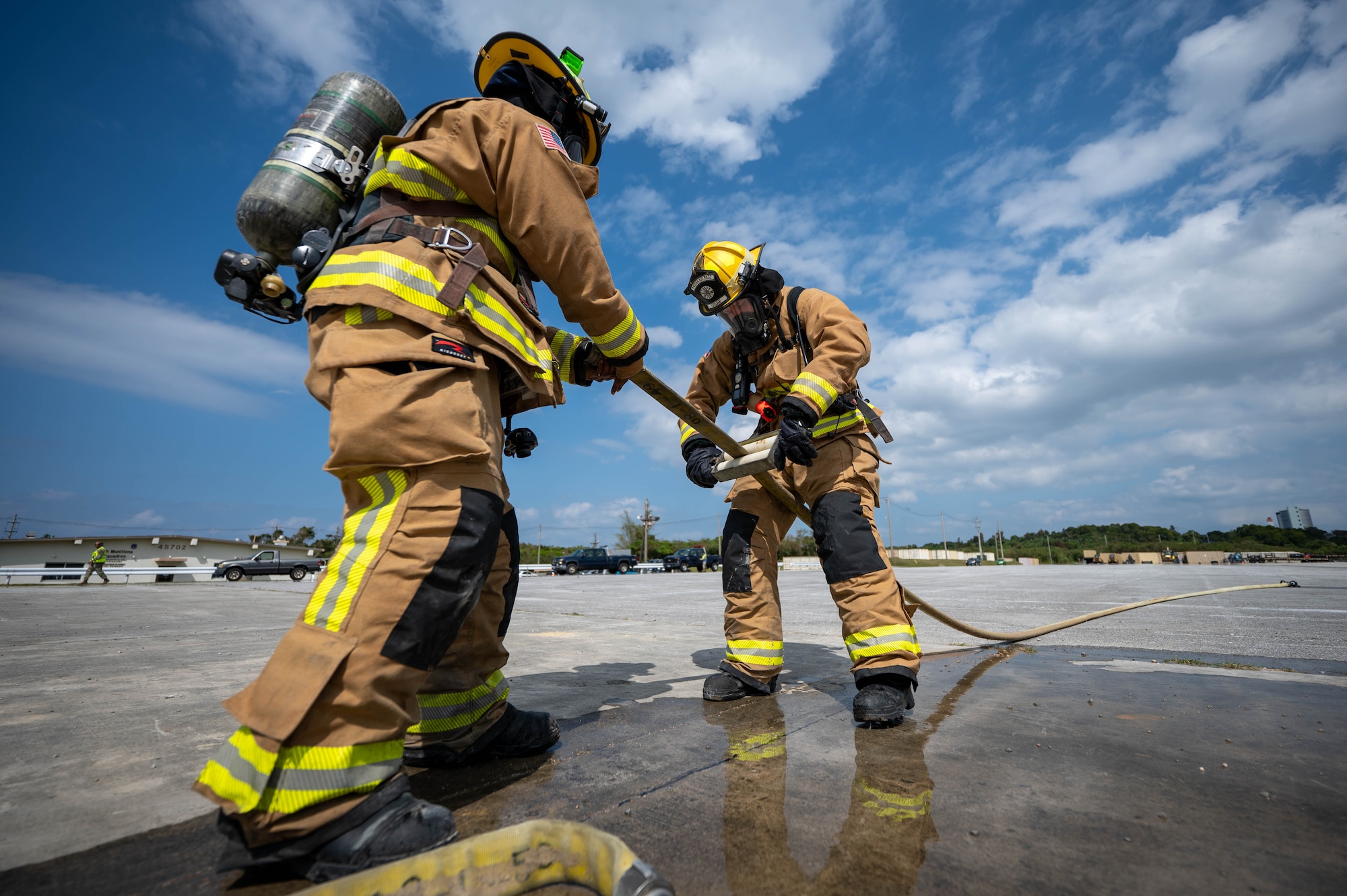 U.S. Air Force Airman 1st Class Nasir Medina, left, and Alexander Kaparchuk, 18th Civil Engineer Squadron firefighters, unhook a hose during U.S. Air Force-led operational exercise Beverly Midnight 26 at Kadena Air Base, Japan, Mar. 10, 2026. The synchronization of our forces enables the U.S. to serve as a premier partner to Japan. (U.S. Air Force photo by Airman 1st Class Francisco Huerta)