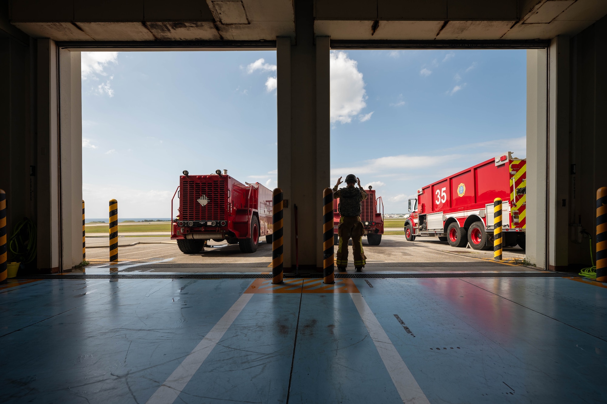 U.S. Air Force Airman 1st Class Alexander Kaparchuk, 18th Civil Engineer Squadron firefighter, guides a fire truck back into bay after successfully completing a training exercise during U.S. Air Force-led operational exercise Beverly Midnight 26 at Kadena Air Base, Japan, Mar. 10, 2026. Training events like this improve coordination and readiness across allied forces in the Indo-Pacific. (U.S. Air Force photo by Airman 1st Class Francisco Huerta)