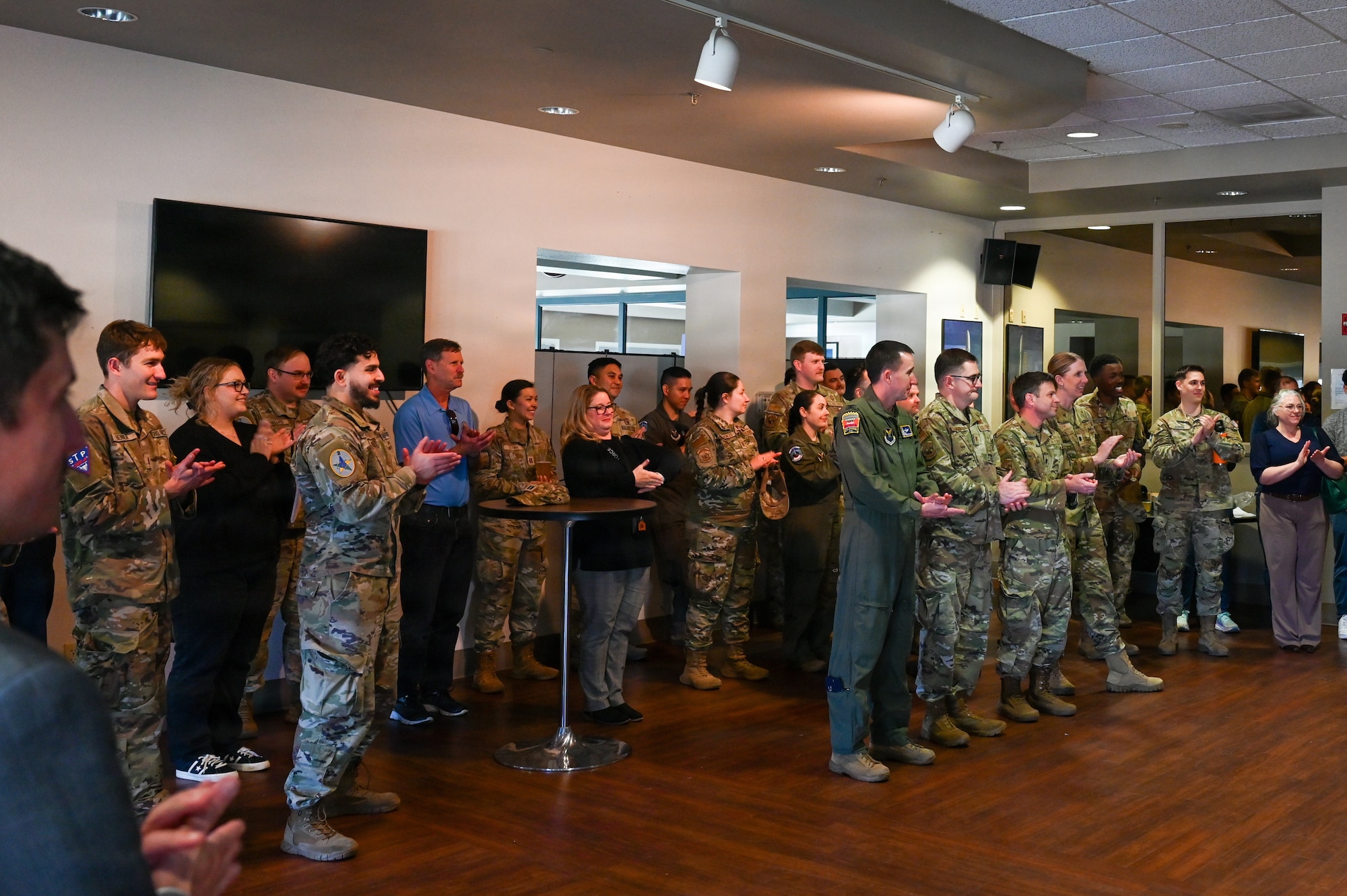 People in a large group clap.