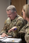 Col. Michelle M. Williams, U.S. Army Financial Management Command commander, right, briefs Lt. Gen. Christopher O. Mohan, U.S. Army Materiel Command commanding general, center right, at Fort Knox, Ky., March 4, 2026. Mohan visited with USAFMCOM’s command team, Soldiers and civilian employees during an AMC major subordinate command update. (U.S. Army photo by Pvt. 1st Class Arpita Singh)