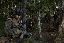 U.S. Marines with Lima Company, Battalion Landing Team 3rd Battalion, 1st Marine Regiment, 31st Marine Expeditionary Unit, prepare to raid a simulated enemy force as a part of Iron Fist 26 at Landing Zone Dodo, Camp Hansen, Okinawa, Japan, March 6, 2026. T