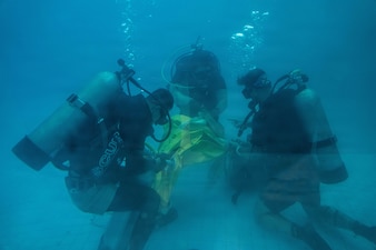 U.S. Navy Divers, assigned to Commander, Task Group 73.6/Mobile Diving and Salvage Unit 1 (CTG 73.6/MDSU 1, Co. 1-3), Royal Thai Navy (RTN) Dive Unit One divers, and Republic of Korea Navy (ROKN) Underwater Construction Team divers, secure an inflatable buoy to simulated ordnance during an underwater rigging and rappelling evolution as part of Cobra Gold 2026 in Thailand, Feb. 25, 2026.