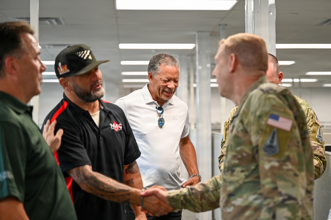 People shaking hands and smiling in building