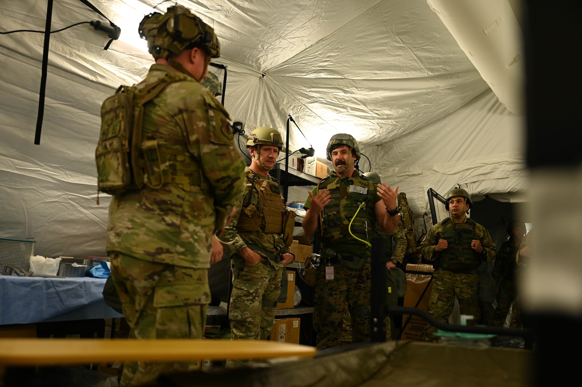 U.S. Navy Cmdr. Henry Sander, assigned to the 3rd Medical Battalion anesthesiologist, 3rd Marine Logistics Group, right, briefs U.S. Air Force Brig. Gen. John Gallemore, 18th Wing commander, during a USAF-led operational exercise Beverley Midnight 26 at Kadena Air Base, Japan, March 10, 2026. The Expeditionary Medical Support facility allows mobile deployment of medical treatment facilities in any location, allowing medical personnel to treat casualties in austere locations (U.S. Air Force photo by Airman 1st Class Amy Kelley)