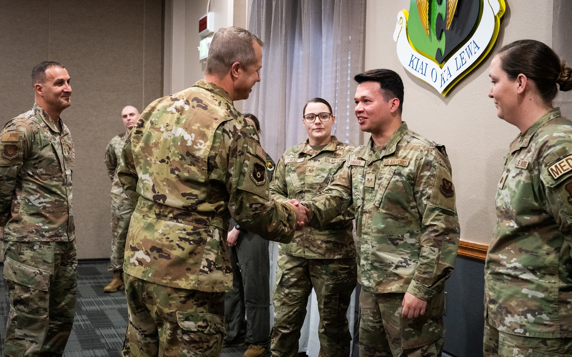 Maj. Gen. Ty Neuman (left) coins Staff Sgt.
Joseph Johnson (right) via a handshake.