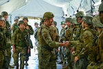 U.S. Air Force Brig. Gen. John Gallemore, 18th Wing Commander, greets Airmen assigned to the 18th Medical Group and service members assigned to the U.S. Navy Ground Surgical Team during an USAF-led operational readiness exercise, Beverley Midnight 2026, at Kadena Air
Base, Japan, March 10, 2026.