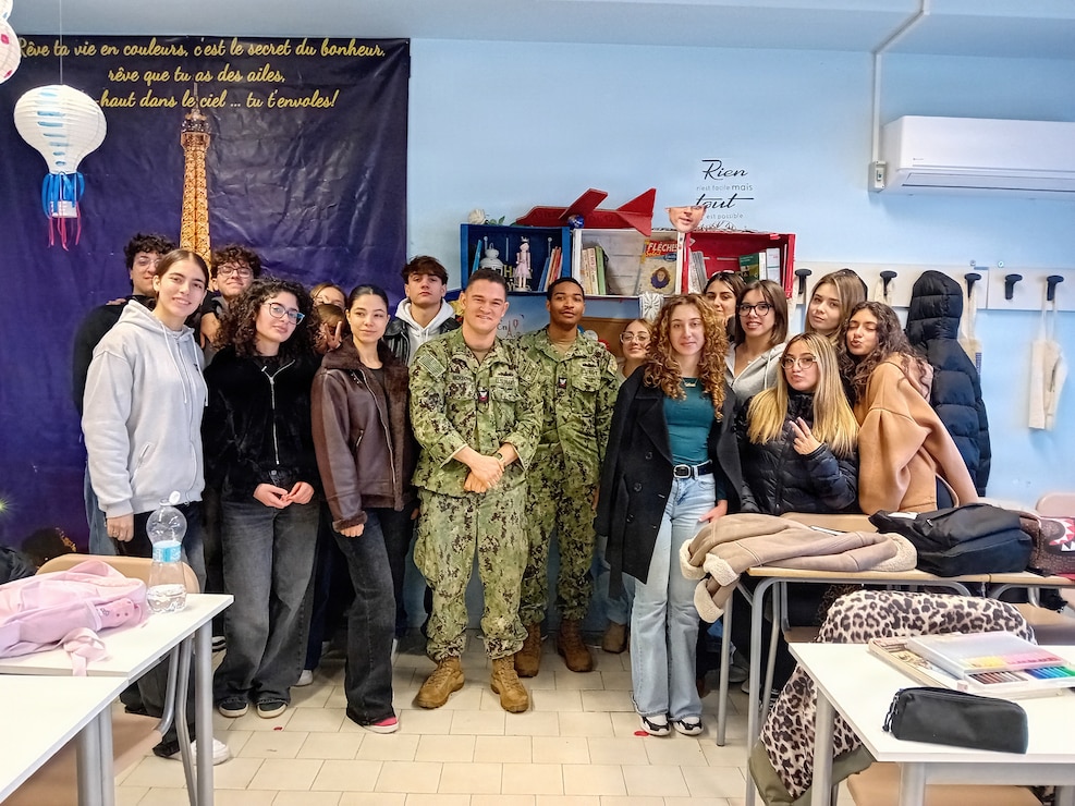 NAPLES, Italy (Jan. 30, 2026) Italian students from High School Piero Calamandrei in Naples, Italy, engage with U.S. Navy Petty Officer 2nd Class Leonard Reuben Jones and U.S. Navy 1st Class Kyle Mckeown during a language and cultural exchange event on Jan. 30, 2026. The engagement is part of U.S. Naval Support Activity (NSA) Naples' Italian Students Engagement Program (ISEP). ISEP facilitates the exchange of U.S. culture with Italian students to strengthen intercultural understanding. NSA Naples is an operational base, home to over 50 commands and 8,500 personnel, providing crucial support for U.S. and allied forces across Europe, Africa, and the Central Command's areas of responsibility. From air and port operations to force protection and logistics, the base ensures combat readiness while prioritizing the well-being of service members and their families. (U.S. Navy courtesy photo by Teresa Merola)