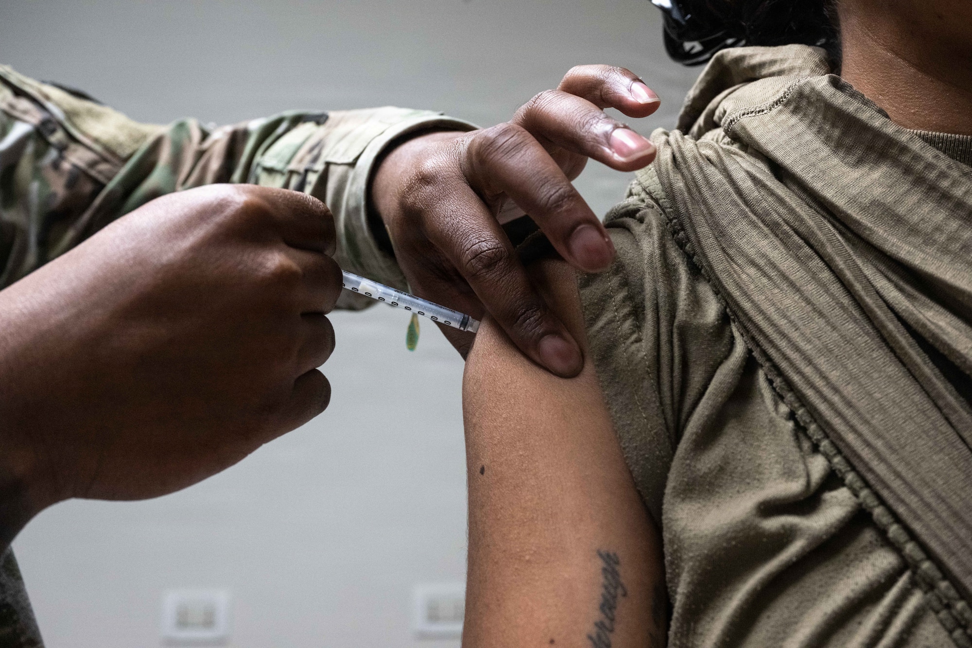 An Airman administers a vaccine.