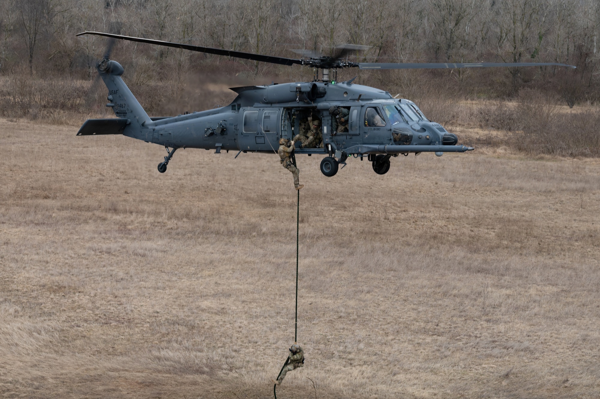 An Airman repels form a helicopter.