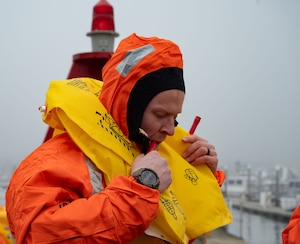 U.S. Air Force Airman 1st Class Connor Davidson, 305th Operations Support Squadron aircrew flight equipment technician, inflates a life vest during Exercise Neptune’s Gauntlet at U.S. Coast Guard Station Atlantic City, N.J., Feb. 17, 2026. The water survival training allowed Airmen to monitor survival environment and maintain mission readiness. (U.S Air Force photo by Airman 1st Class Haeleigh Bayle)