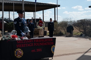 U.S. Tech. Sgt. Daniel Merritt, 312th Training Squadron instructor, rings the ceremonial bell during the final call at the annual Department of War Fallen Firefighter Memorial, Goodfellow Air Force Base, Texas, Mar. 6, 2026. The ringing of a bell is a tradition that harks back to the earliest days of firefighting tradition. (U.S. Air Force photo by Senior Airman Brian Lummus)