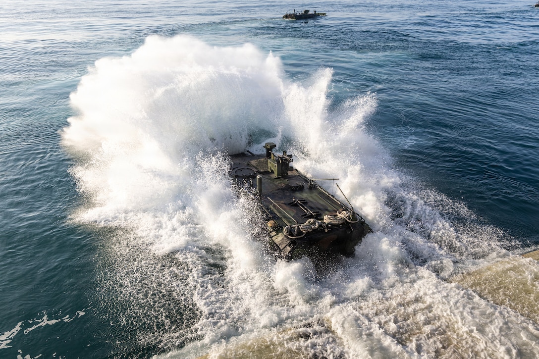 A U.S. Marine Corps Amphibious Combat Vehicle with Alpha Company, 2nd Assault Amphibian Battalion, 2nd Marine Division, launches from the well deck of the San Antonio-class amphibious transport dock ship USS Arlington (LPD 24), during Type Commander’s Amphibious Training 26.1 off the coast of North Carolina, March 3, 2026. TCAT is a military exercise designed to enhance mobility and integration between the U.S. Marine Corps and the U.S. Navy. It allows Marines and Sailors to gain hands-on experience of working side by side in amphibious planning and operations, including the use of multiple surface connectors and air platforms. The training focuses on improving the necessary skills for real-world operations and effective collaboration between Marine Corps and Naval teams. (U.S. Marine Corps photo by Cpl. Osmar VasquezHernandez)
