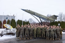Norwegian Armed Forces personnel, U.S. Marines, and Sailors with the exercise Cold Response 26 Combined Joint Logistics Support Group pose for a group photo after a transfer of authority ceremony at Kjeller Air Base, Norway, Feb. 27, 2026. A key component of NATO's enhanced vigilance activity Arctic Sentry, exercise Cold Response 26 is a Norwegian-led winter military exercise designed to enhance collective defense capabilities and ensure U.S. readiness to rapidly deploy and seamlessly operate alongside NATO Allies in challenging arctic conditions. (U.S. Marine Corps photo by Sgt. Rafael Brambila-Pelayo)