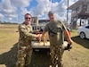 1st Sgt. Jonathan Merck, with the U.S. Army 310th Psychological Operations Company, U.S. Army Reserve, poses with Mr. Welborn and his hunting dog that he rescued during exercise Sentry South 26-2, at Camp Shelby Joint Forces Training Center, Mississippi, Feb. 28, 2026. Sentry South 26-2 is a large force employment exercise focused on major combat operations and joint maritime opportunities in a contested or degraded operational environment. Sentry South 26-2 applies joint and combined warfighting doctrine against realistic and robust enemy integrated threat systems, all while under safe and controlled conditions. (Courtesy photo 1st Sgt. Jonathan Merck)