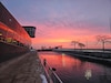 Orange and purple sunrise at the Chicago Harbor Lock looking over Lake Michigan.
