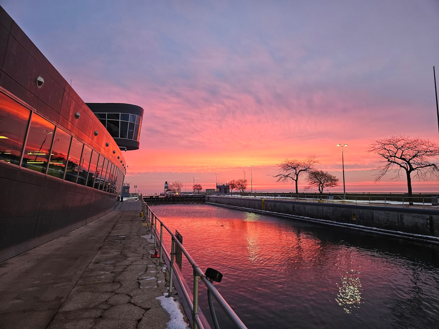 Orange and purple sunrise at the Chicago Harbor Lock looking over Lake Michigan.