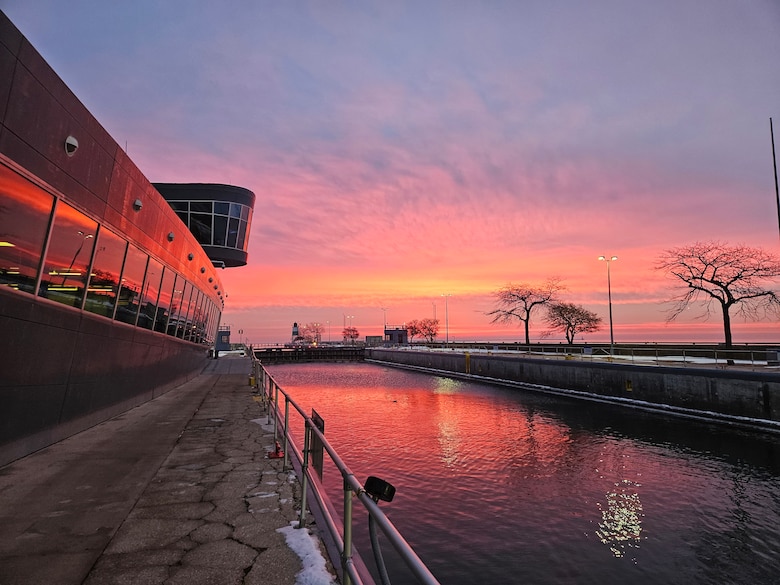 Orange and purple sunrise at the Chicago Harbor Lock looking over Lake Michigan.