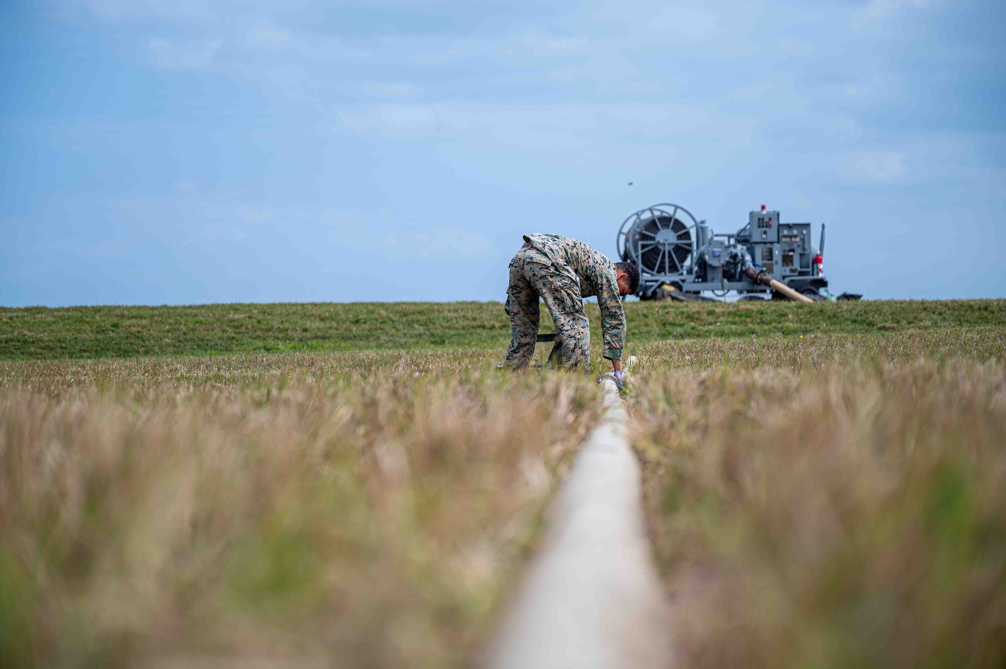 person checks fuel hose