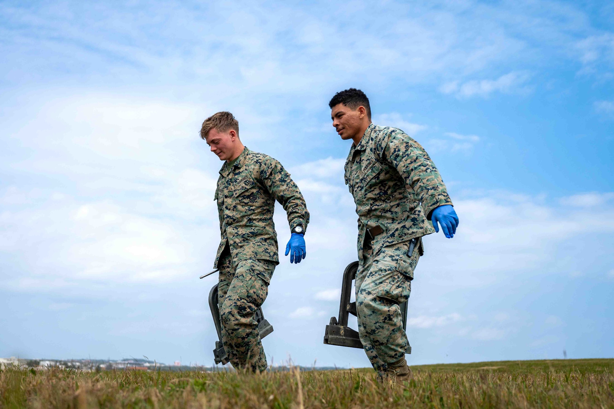 two people carry fuel clamps