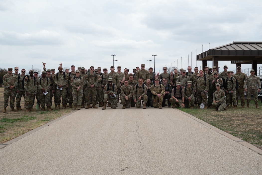 Participants pose for a group photo before the inaugural Noncommissioned Officer Ruck March at Goodfellow Air Force Base, Texas, March 5, 2026. The ruck was held to honor all service members transitioning into the NCO Corps. (U.S. Air Force photo by Senior Airman Brian Lummus)