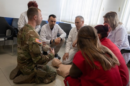 Florida Army National Sgt. Benford Rosenfeldt, a combat medic and platoon sergeant assigned to Kosovo Force, or KFOR, Regional Command-East’s Task Force Medical, leads hands‑on lifesaving training for local health clinic providers in Obilić, Kosovo, on Feb. 24, 2026.