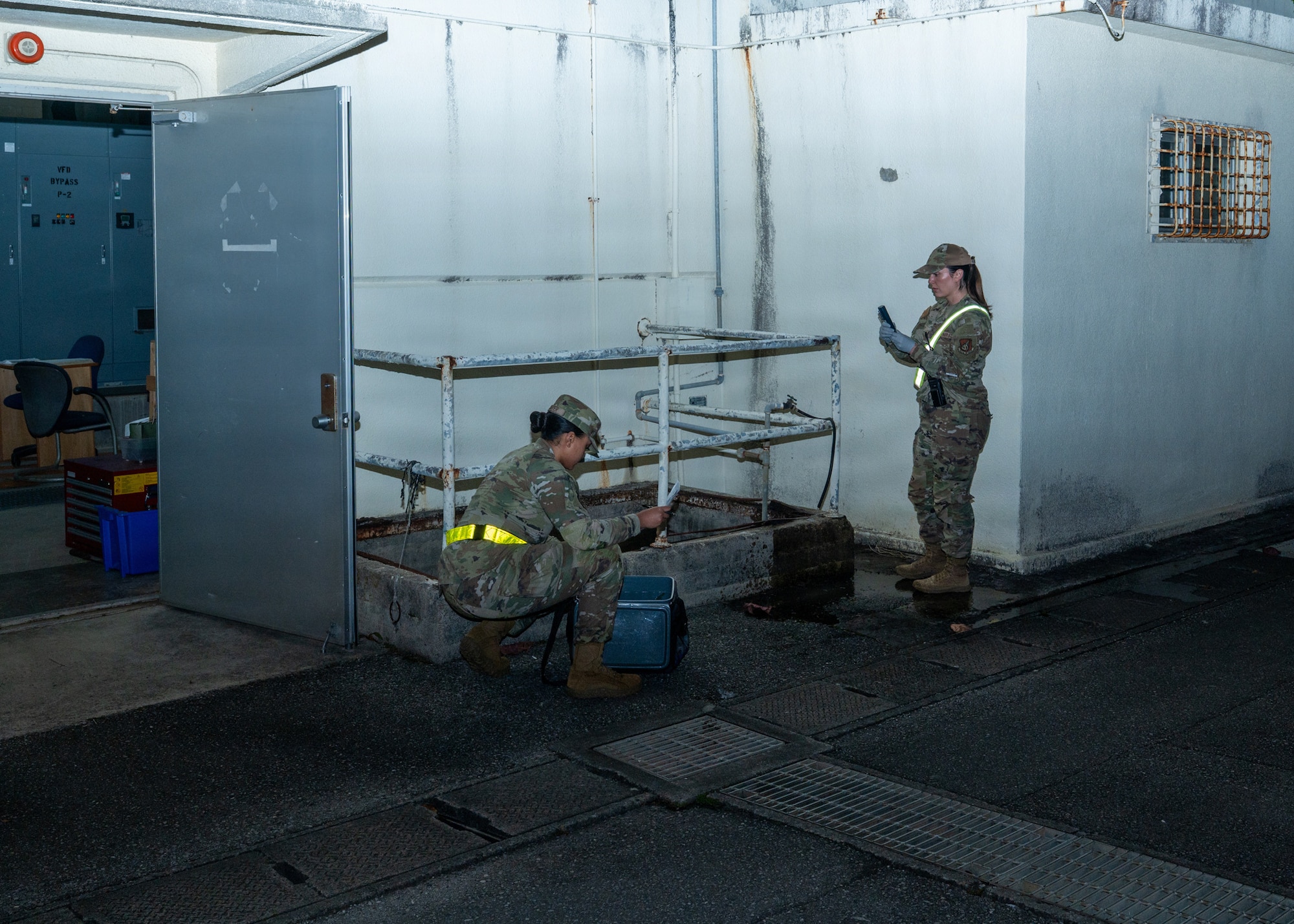 Two women in an alley with test tubes