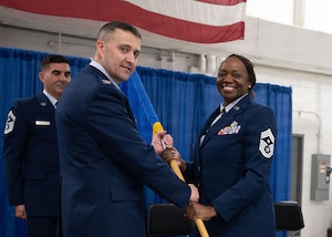 Command Chief Master Sgt. Sonja Williams relinquishes the 174th Attack Wing colors to Col. Brett Batick, the 174th Attack Wing commander, during a change of responsibility ceremony at Hancock Field Air National Base March 7, 2026. Williams, who served as the unit's senior enlisted leader since 2023, is slated to retire later this year after 28 years of military service. (U.S. Air National Guard Photo by Tech. Sgt. Duane Morgan)