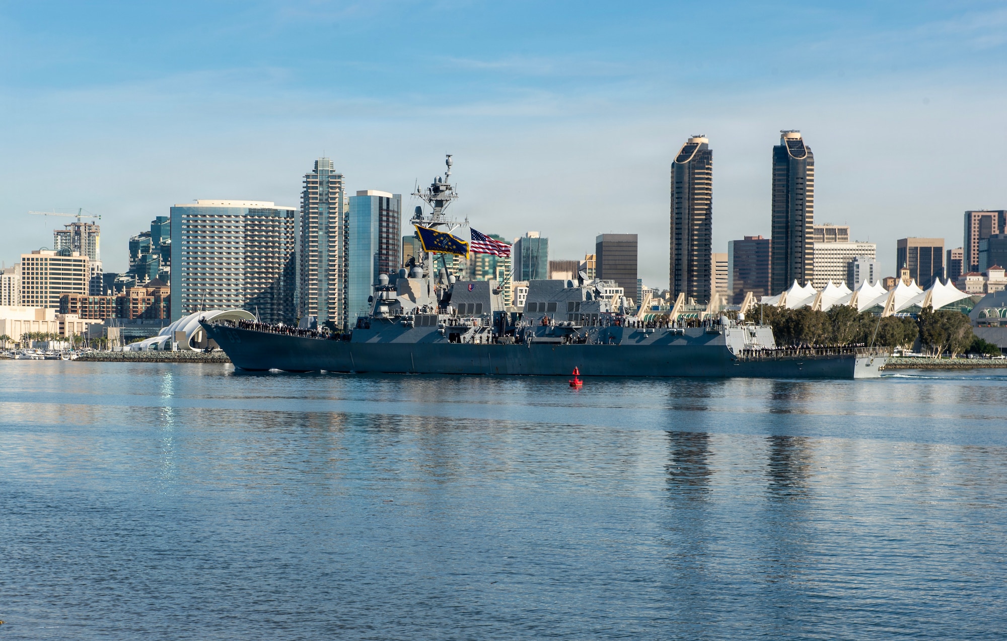 Arleigh Burke-class guided-missile destroyer USS Mustin (DDG 89) transits San Diego Bay, Feb. 23, 2026. The ship departed Naval Base San Diego and will forward deploy to Yokosuka, Japan, as part of a scheduled rotation of forces in the Pacific. (U.S. Navy photo by Mass Communication Specialist 2nd Class Joshua Martinez)