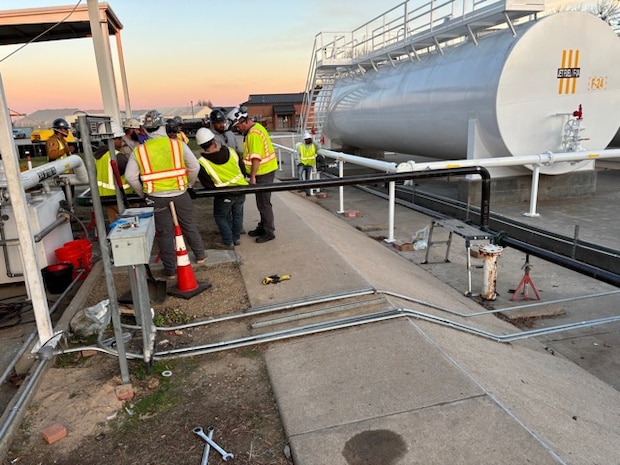 Huntsville Center Fuels Program team member and contractors work on fuel piping repairs.