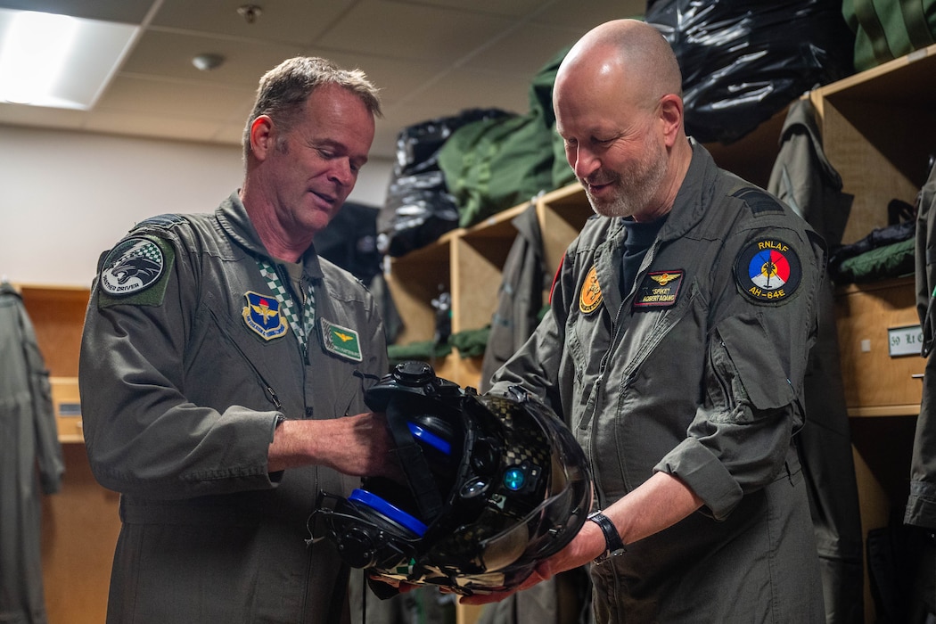 Royal Netherlands Air Force Lt. Col. Joseph Luijsterburg, RNLAF senior representative at the 308th Fighter Squadron, and Royal Netherlands Air and Space Force Maj. Gen. Robert Adang (right), RNLAF deputy commander, examine an F-35 helmet, Mar. 3, 2026, at Luke Air Force Base, Arizona.