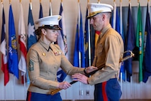 U.S. Marine Corps Sgt. Maj. Sarah E. Bickel, left, the former sergeant major of Recruiting Station Kansas City, passes a noncommissioned officer sword to Maj. Pat Leet, right, the commanding officer of Recruiting Station Kansas City, during her retirement ceremony in Kansas City, Missouri, Feb. 21, 2026. The ceremony was held in honor of Bickel, who served honorably in the Marine Corps for 23 years. (U.S. Marine Corps photo by Lance Cpl. Kayla Goldman)