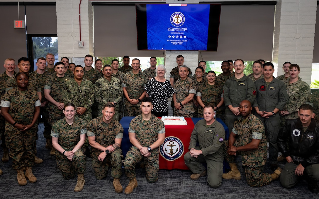 U.S. Marines and Sailors pose for a photo with Ms. Miranda, director of the Navy-Marine Corps Relief Society, Marine Corps Base Camp Pendleton, during the Active Duty Fund Drive at MCB Camp Pendleton, Calif., March 9, 2026. The fund drive raises donations to support Navy and Marine Corps personnel and their families experiencing financial hardship. (U.S. Marine Corps photo by Cpl. Paschal)