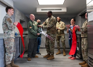 service members celebrate cutting of ribbon.