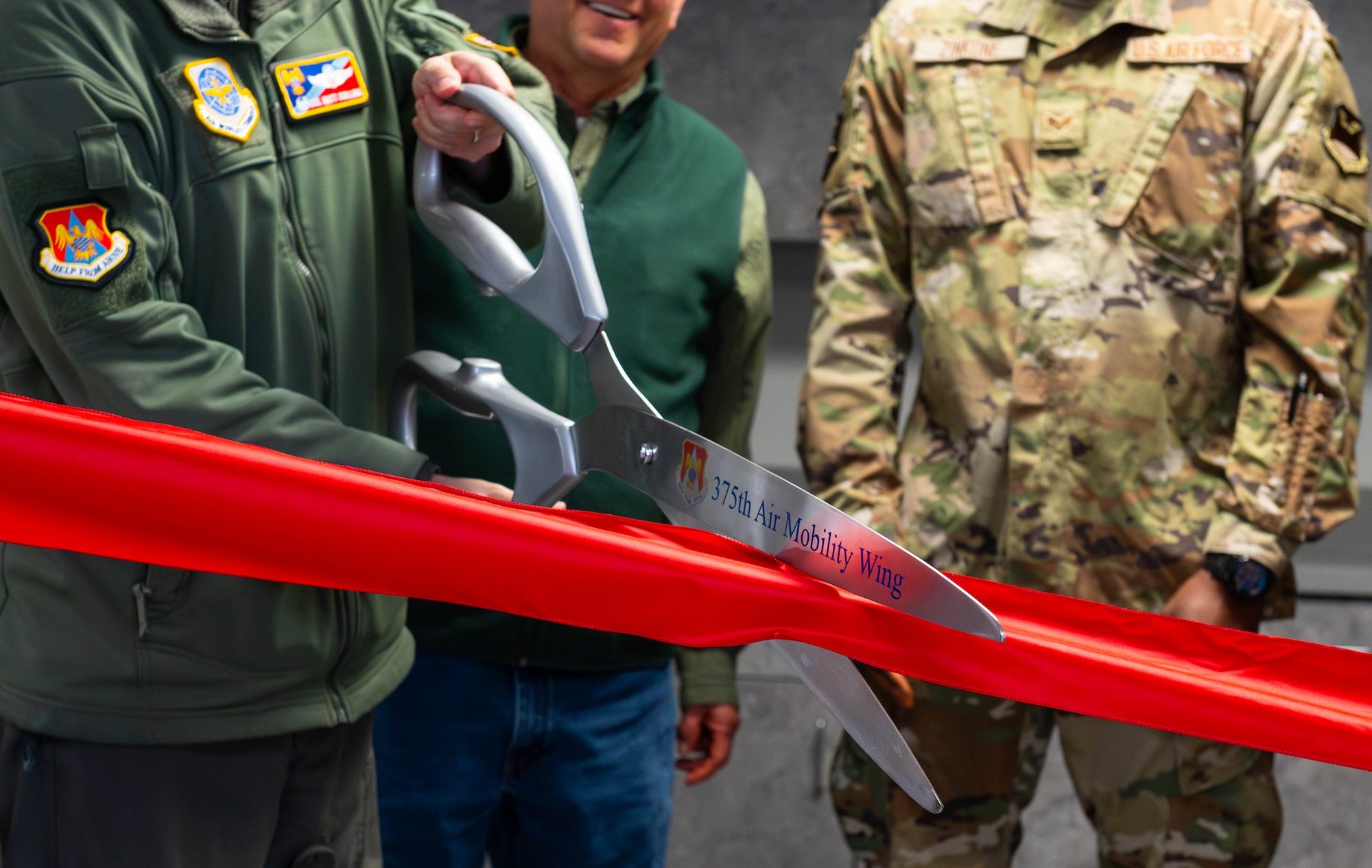 large scissors cut a ribbon