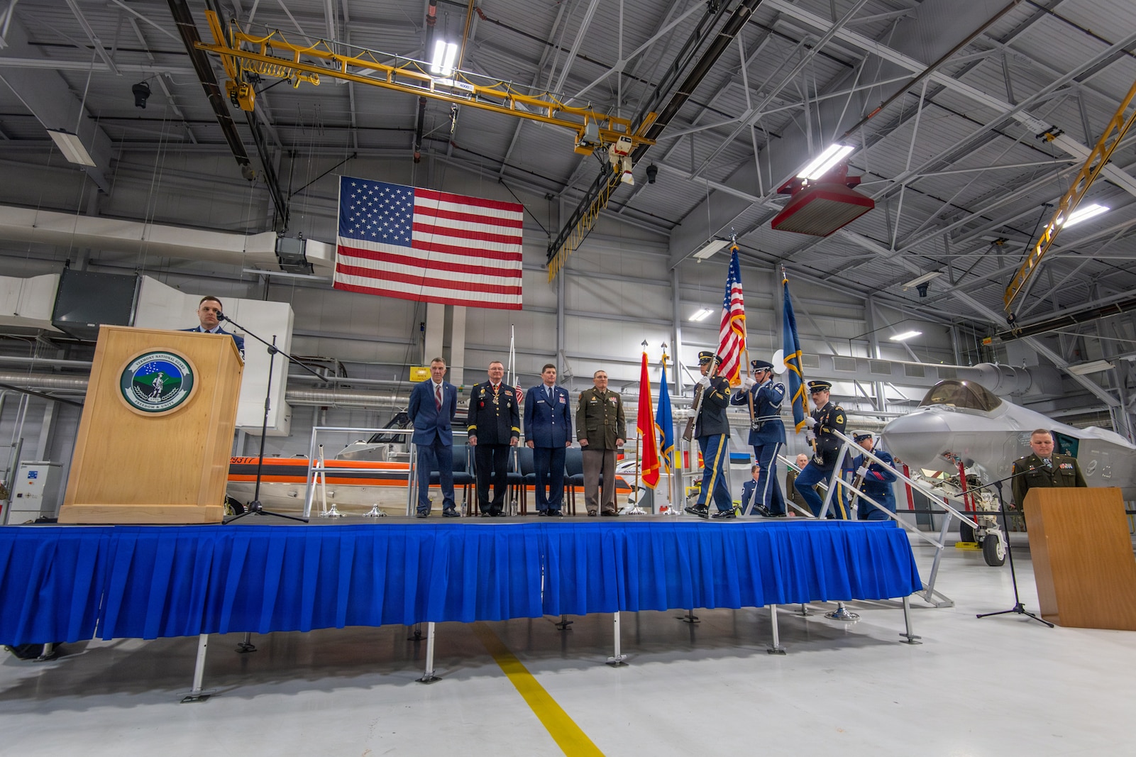 Photo of The official party standing for the presentation of colors during the Adjutant General change of command ceremony at the Vermont Air National Guard Base, South Burlington, Vermont, March 7, 2026.
