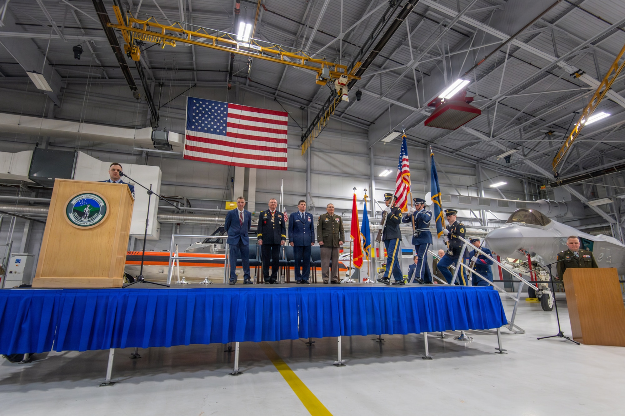 Photo of The official party standing for the presentation of colors during the Adjutant General change of command ceremony at the Vermont Air National Guard Base, South Burlington, Vermont, March 7, 2026.