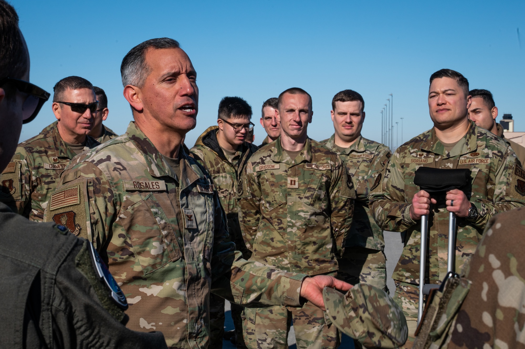 A photo of a man speaking to a group of people.
