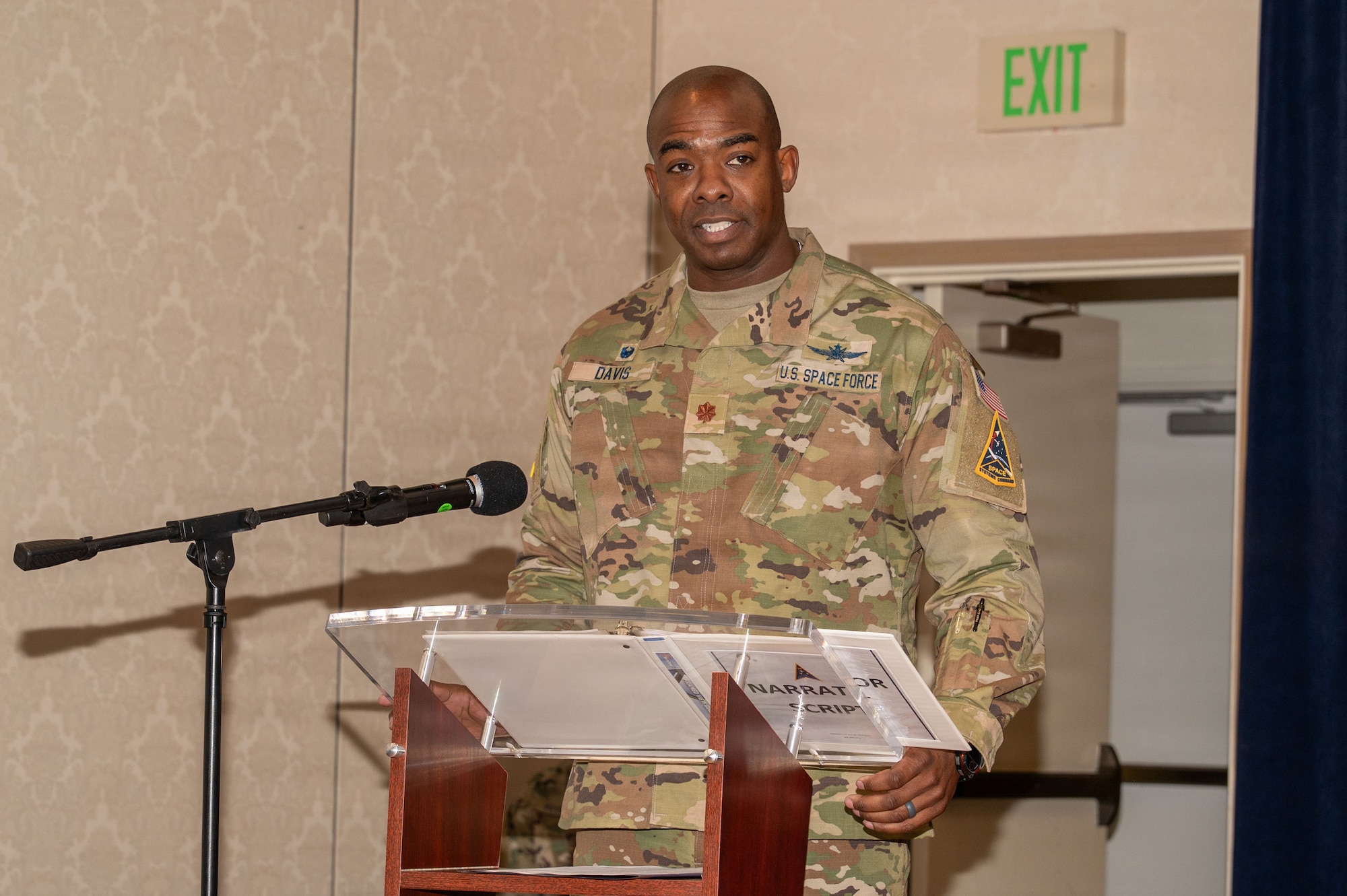 a person stands at a podium on a stage and speaks