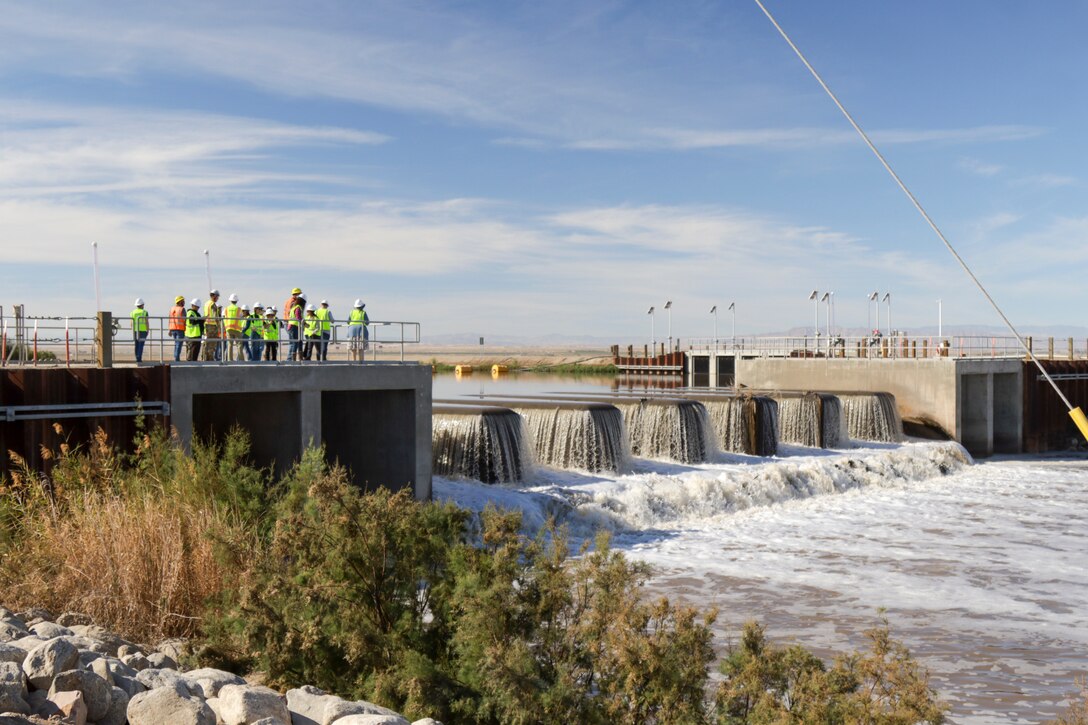 U.S. Army Corps of Engineers senior leaders, California state agency partners and contactors meet Feb. 24 to observe the New River inflow heading toward the Salton Sea Species Conservation Habitat. The inflow waters are aerated to encourage nutrient breakdown and mitigate harmful algal blooms before it flows into the constructed wetlands.