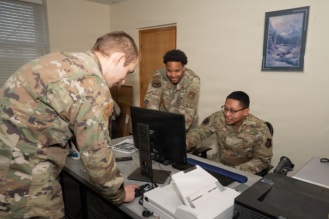 U.S. Air Force Airmen 1st Class Jayden Ward (middle) and Danyelle Miller (right), 354th Force Support Squadron military personnel flight (MPF) customer support technicians, create a new identification card for an Airman at Eielson Air Force Base, Alaska, March 3, 2026.