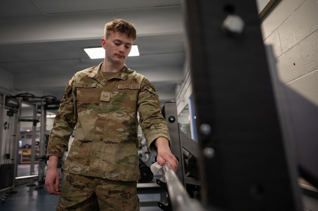 U.S. Air Force Airman 1st Class Emery Dewitt, 354th Force Support Squadron fitness journeyman, wipes down a barbell at Eielson Air Force Base, Alaska, March 5, 2026.