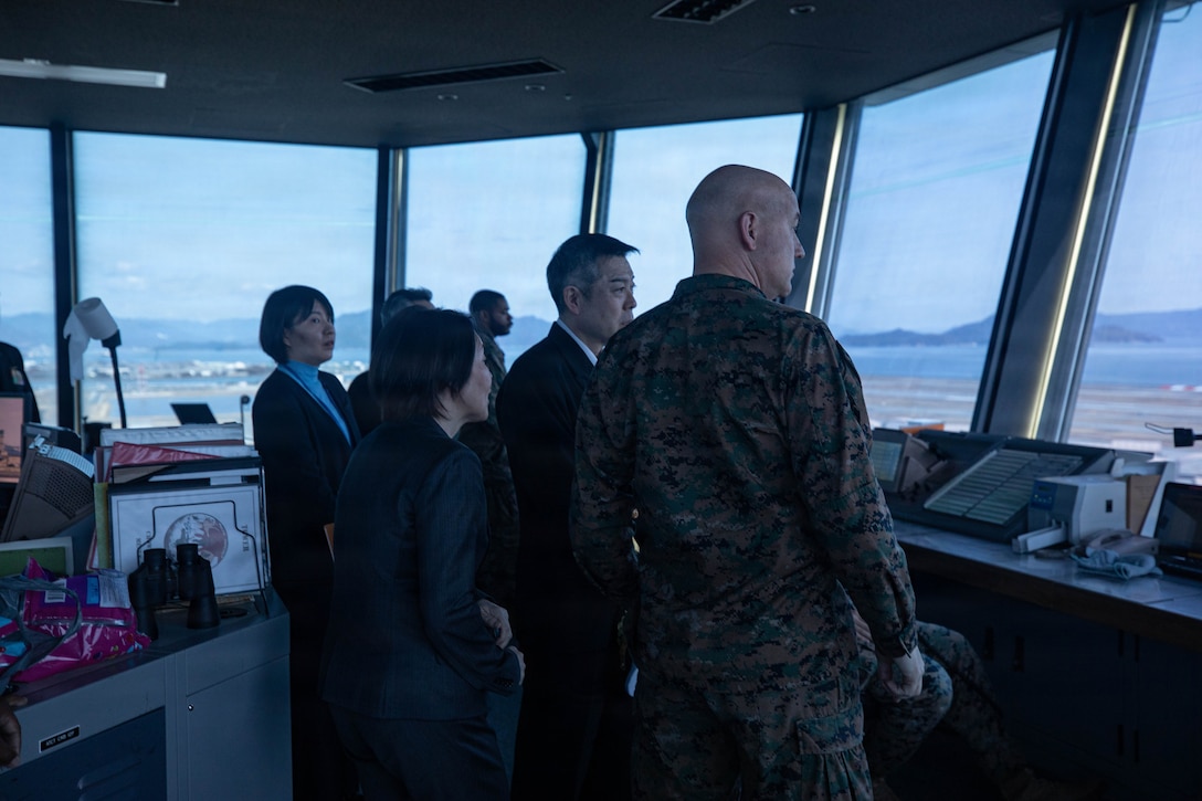 U.S. Marine Corps Col. Kenneth Rossman, right, the commanding officer of Marine Corps Air Station Iwakuni, and a native of Pittsburgh, Pennsylvania, and Japan Maritime Self-Defense Force Adm. Masahiro Matsuura, center, Director General of the Japan Self-Defense Force General Affairs Department, tour the Air, Traffic and Control tower at Marine Corps Air Station Iwakuni, Japan, March 5, 2026. The United States Forces, Japan leadership visited MCAS Iwakuni to learn about the air station and its capabilities. (U.S. Marine Corps photo by Sgt. Peter Rawlins)