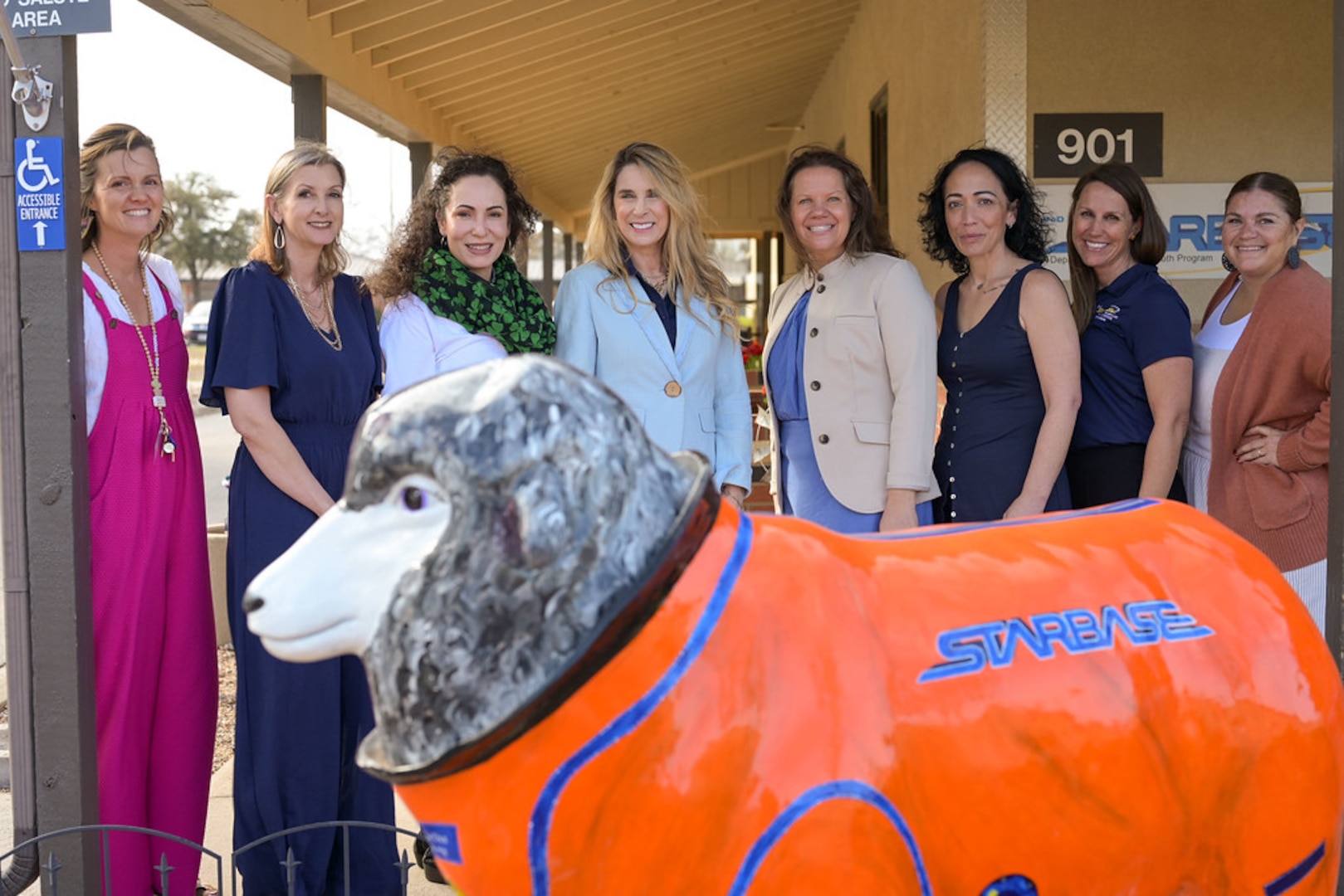 Mrs. Cindy Wilsbach, wife of Air Force Chief of Staff Gen. Ken Wilsbach, and Dr. Doniel Wolfe, wife of Chief Master Sgt. of the Air Force David Wolfe, take a photo with other military spouses at Goodfellow’s STARBASE youth education center, Goodfellow Air Force Base, Texas, March 10, 2026.