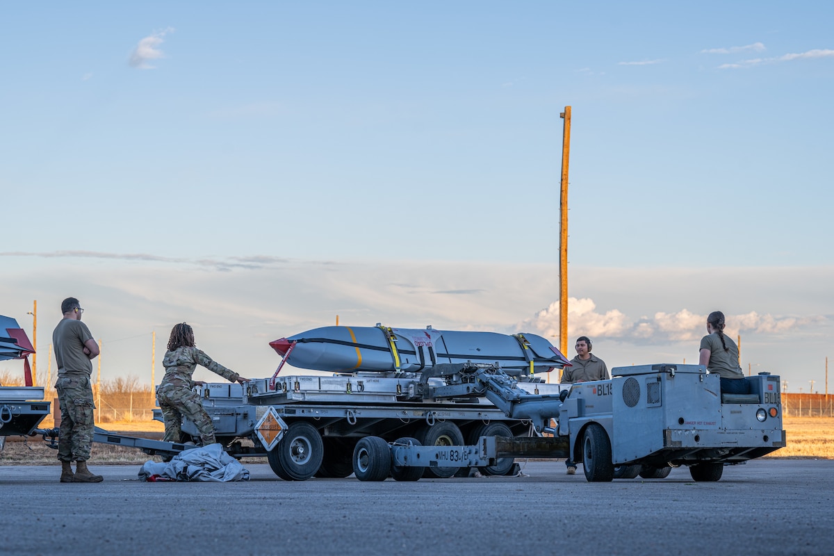 U.S. Airmen assigned to the 7th Munitions Squadron prepare to load a Joint Air-to-Surface Standoff Missile using a Launcher Load Frame at Dyess Air Force Base, Texas, Feb. 14, 2026. Launcher Load Frames were used for the first time at Dyess on this JASSM loadout, providing 7th MUNS Airmen with valuable experience to improve configuration times on the flightline. (U.S. Air Force photo by Airman 1st Class Caleb Schellenberg)