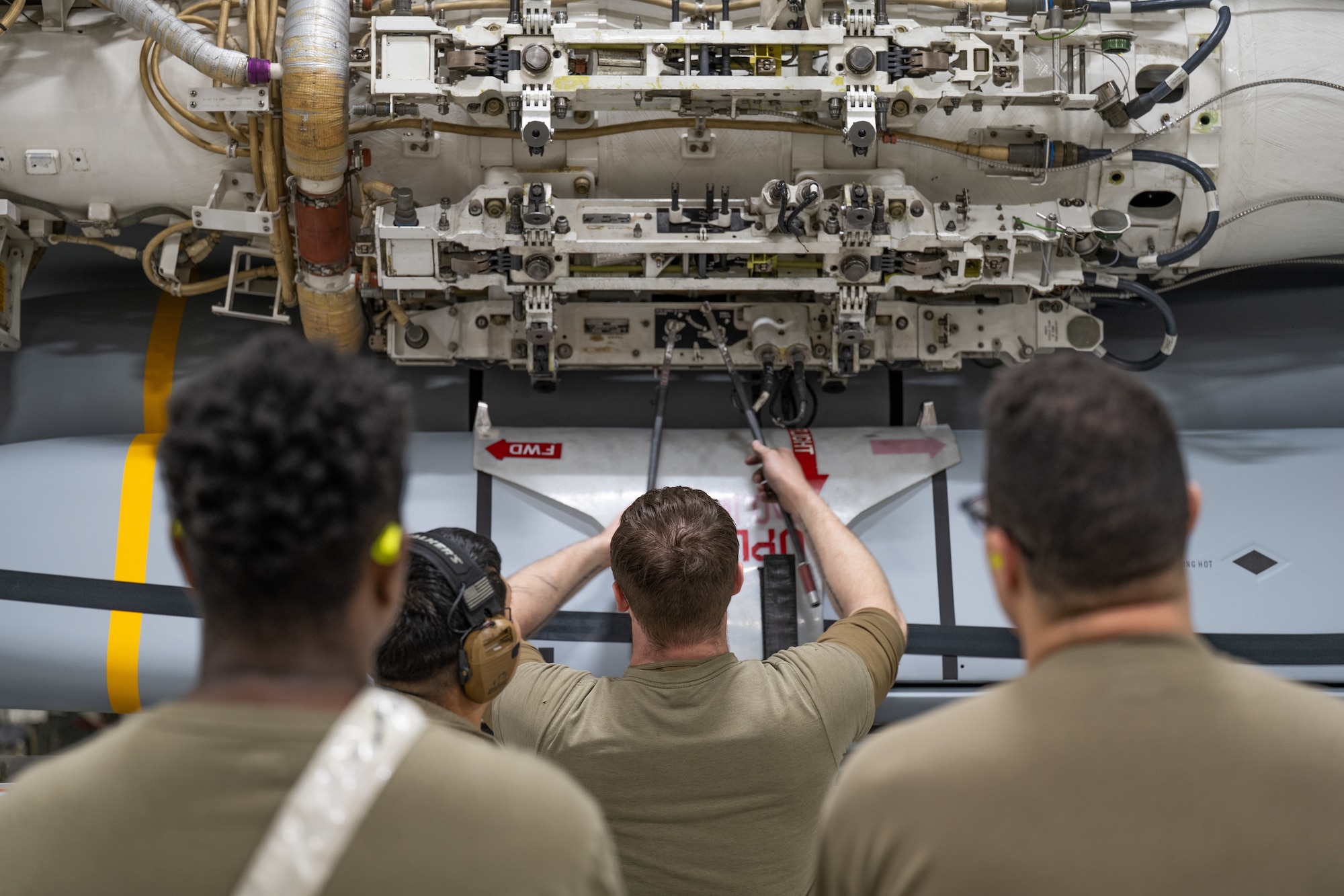 U.S. Airmen assigned to the 7th Munitions Squadron load a Joint Air-to-Surface Standoff Missile at Dyess Air Force Base, Texas, Feb. 14, 2026. Launcher Load Frames were used for the first time during the JASSM loadout, providing 7th MUNS Airmen with valuable experience to improve configuration times on the flightline. (U.S. Air Force photo by Airman 1st Class Caleb Schellenberg)